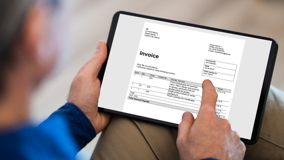 Employee approving invoice on tablet